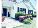 Charming front porch with lush landscaping and a welcoming entrance at 486 Village Cir, Stockbridge, GA 30281