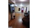 Basement living room with hardwood flooring and comfortable leather couches at 1071 Ponderosa Park Dr, Forest Park, GA 30297