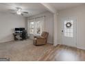 Bright living room with large windows, a cozy chair, and a dedicated workspace at 168 Warbler Way, Mcdonough, GA 30253