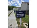 Street view showing signage promoting 100% financing at Morning Creek Forest community at 6120 Ripple Way # 46, South Fulton, GA 30349