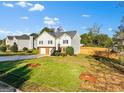 Charming two-story home features a well-manicured lawn, mature landscaping, and a welcoming entrance at 5284 Benjamin Trl, Ellenwood, GA 30294