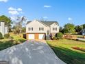 Well-maintained two-story home features an attached two-car garage, brick veneer, and a long driveway at 5284 Benjamin Trl, Ellenwood, GA 30294
