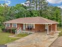 Cozy single-story brick home featuring a covered carport and a quaint front porch, perfect for relaxing outdoors at 2609 Lake Harbin Rd, Morrow, GA 30260