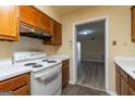 Kitchen featuring a white range oven and view to living room at 2986 Parc Lorraine, Lithonia, GA 30038