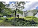 Picture of the house with a large tree in a wooded backyard with a outbuilding at 3133 Callie Still Rd., Lawrenceville, GA 30045