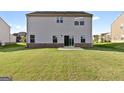 Expansive backyard featuring a lush green lawn and a sliding glass door for easy access to the home at 838 Maduro Way, Mcdonough, GA 30253