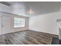 Bright living room with a door to the front porch and updated flooring at 325 Espana St, South Fulton, GA 30349