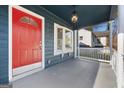 Inviting front porch with a bright red door and classic white railing at 2584 Oldknow Nw Dr, Atlanta, GA 30318