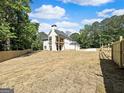 Spacious backyard with a lovely two-story home featuring a deck and attached garage at 1461 Leach Dr, Lawrenceville, GA 30045