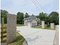 Long driveway with brick entrance leading to a spacious three-car garage and beautiful home at 1461 Leach Dr, Lawrenceville, GA 30045
