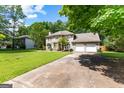 Traditional home featuring a long driveway and a manicured front lawn at 224 Claridge Curv, Peachtree City, GA 30269