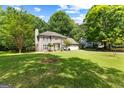 Landscaped front lawn and two-story home, surrounded by mature trees at 224 Claridge Curv, Peachtree City, GA 30269