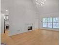 Bright living room with fireplace, hardwood floors, and large windows at 1155 Graystone Xing, Alpharetta, GA 30005