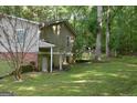 Spacious backyard featuring a walkout basement, lush trees, and plenty of room for outdoor activities at 142 Carrollwood Dr, Fayetteville, GA 30215