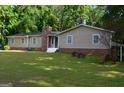 Single-story home featuring multiple windows and a well-maintained lawn at 142 Carrollwood Dr, Fayetteville, GA 30215