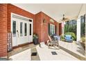 Welcoming front porch with tiled flooring, ceiling fan, and comfortable seating, perfect for relaxing outdoors at 270 Morrow Rd, Newborn, GA 30056