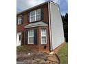 Brick townhome with vinyl siding on the side, and a small strip of grass at 2700 Marlin Dr, Mcdonough, GA 30253