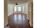Bright living room with hardwood floors, fresh paint, and natural light from the bay window at 2700 Marlin Dr, Mcdonough, GA 30253