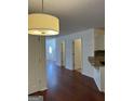 Open living space showing hardwood flooring and transitions into other areas of the home at 2700 Marlin Dr, Mcdonough, GA 30253