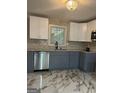 Bright kitchen features stainless steel appliances, granite countertops, and stylish white and gray cabinetry at 2953 Meadowview Se Dr, Atlanta, GA 30316