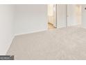 Bedroom featuring plush carpet with a bathroom visible through the doorway at 7222 Lacey Dr. # 127, Douglasville, GA 30134