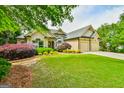 Inviting home with lush landscaping and a side-entry garage at 3435 Vista Creek Dr, Dacula, GA 30019