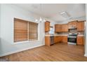 Bright eat-in kitchen with stainless steel appliances, wood cabinets, and wood-look flooring at 1870 Wildcat Trace Cir, Lawrenceville, GA 30043