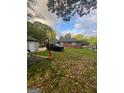 Expansive backyard offers space for entertaining, with a grassy lawn and mature trees at 4111 Scott Dr, Forest Park, GA 30297