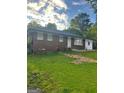 Classic brick ranch home featuring a well-maintained lawn and inviting front entrance at 4111 Scott Dr, Forest Park, GA 30297