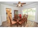 Dining area with wood table, six chairs, and adjacent sunroom with natural light at 101 Bluegill Trce, Peachtree City, GA 30269