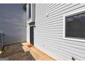 Back door entrance with black metal screen door and 'Stay Awhile' welcome mat, and vinyl siding at 313 Country Club Dr, Jonesboro, GA 30238