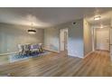 Bright dining room featuring new wood floors, modern chandelier, and a view to the entry hall at 313 Country Club Dr, Jonesboro, GA 30238