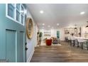 Inviting home foyer with wood floors, a round mirror, and a view into the open-concept living spaces at 1091 Pine St, Conyers, GA 30012