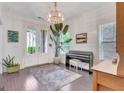 Bright living room with piano, shiplap walls, and natural light from French doors at 405 Bandon Way, Peachtree City, GA 30269