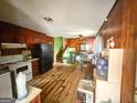 Cozy kitchen with classic appliances, wood paneling, and an open floor plan leading to the stairs at 5637 Sturbridge Way, South Fulton, GA 30349