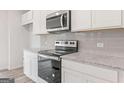 Well-equipped kitchen with stainless steel appliances, white cabinets, and granite countertops at 8504 Polston Pl # 145, Douglasville, GA 30134