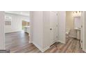 Hallway view leading to a bathroom with wood-look floors, and access to another room at 8501 Polston Pl # 143, Douglasville, GA 30134
