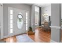 Inviting foyer featuring hardwood floors, a decorative door, and views into the dining area at 1010 Elaine Ct, Mcdonough, GA 30252