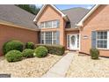 Close-up of the home's front entrance with well-maintained landscaping and welcoming walkway at 1010 Elaine Ct, Mcdonough, GA 30252