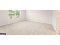 Spacious bedroom with neutral carpet and large windows, providing ample natural light at 8502 Polston Place # 144, Douglasville, GA 30134