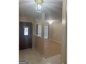 Bright entryway featuring tile flooring, decorative lighting, and an open view to the living area at 6050 Great Oaks Dr, Lithonia, GA 30058