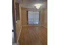 Bright and airy living room showcasing sleek laminate floors, and large bright window at 6050 Great Oaks Dr, Lithonia, GA 30058