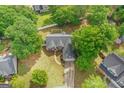 Aerial view of home with mature trees, long driveway, and a well-maintained lawn at 556 Walton Dr, Social Circle, GA 30025
