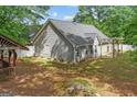 View of home with siding, multiple windows, and a backyard with a covered patio at 556 Walton Dr, Social Circle, GA 30025