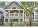This updated condo features a private balcony, manicured shrubs, and a secure fenced front yard at 578 Mcgill Ne Pl # 578, Atlanta, GA 30312