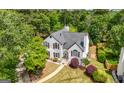 A beautiful two-story home nestled among mature trees with a well-maintained lawn at 9206 Denmeade Trce, Douglasville, GA 30135