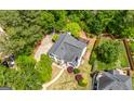A two-story home with gray roof surrounded by mature trees and landscaped yard at 9206 Denmeade Trce, Douglasville, GA 30135