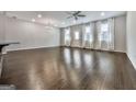Bright and airy living room with hardwood floors, a ceiling fan, and multiple windows at 1020 Broadview Dr, Marietta, GA 30062