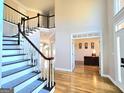 Open foyer with hardwood floors, staircase, and views into the formal areas at 110 Vicarage Ct, Johns Creek, GA 30005
