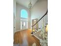 Two-story foyer featuring hardwood floors, large window, and elegant chandelier at 110 Vicarage Ct, Johns Creek, GA 30005